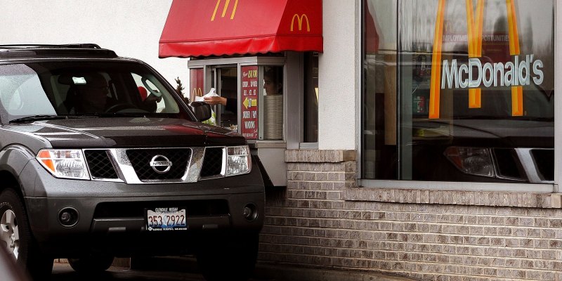 Un cliente ritira il suo ordine a un drive-through di McDonald's. (Photo by Tim Boyle/Getty Images)