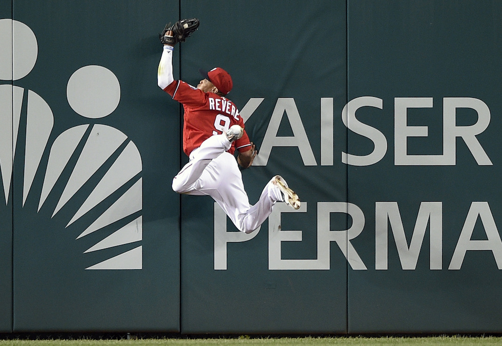 Washington Nationals center fielder Ben Revere hits the wall after he caught a fly ball by Cincinnati Reds' Jay Bruce for the out during the sixth inning of a baseball game, Saturday, July 2, 2016, in Washington. (AP Photo/Nick Wass)