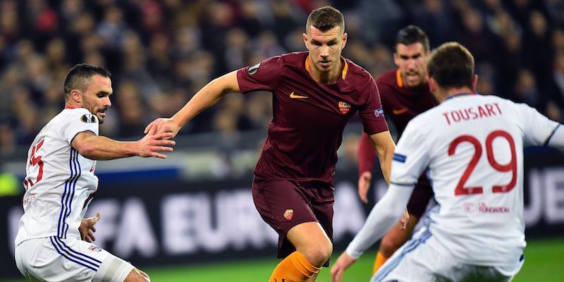 Edin Dzeko fra i giocatori del Lione nella partita di andata (ROMAIN LAFABREGUE/AFP/Getty Images)