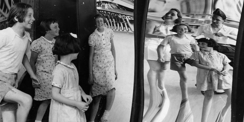 Tre bambine ridono di fronte a uno specchio deformante in un parco divertimenti di Ramsgate, nel Regno Unito, il 12 agosto 1957
(Fox Photos/Getty Images)