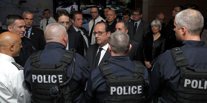 Il presidente francese Francois Hollande con alcuni poliziotti a Parigi (Philippe Wojazer, Pool Photo via AP)
