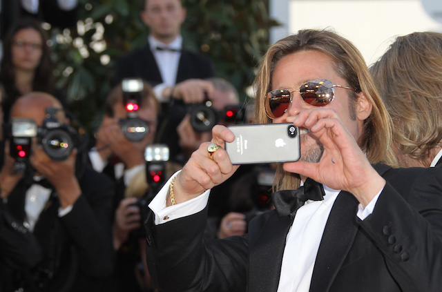 US actor Brad Pitt takes pictures with h
