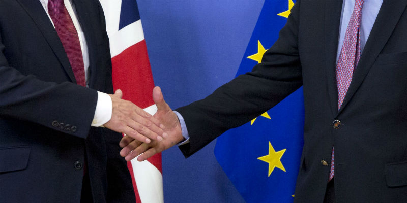La prima stretta di mano tra il capo-negoziatore dell'Unione Europa Michel Barnier, a destra, e quello britannico, David Davis (AP Photo/Virginia Mayo)