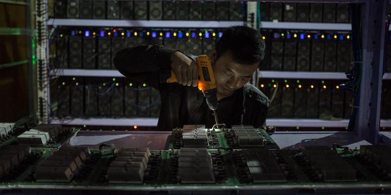 Un uomo al lavoro in una fabbrica di bitcoin nel Sichuan, 27 settembre 2016
(EPA/LIU XINGZHE/CHINAFILE/ANSA)