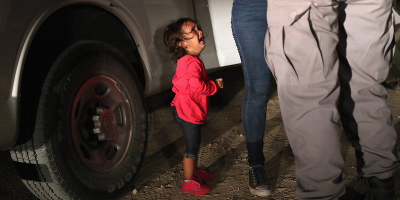 Una bambina piange mentre la madre viene perquisita a McAllen, in Texas (John Moore/Getty Images)