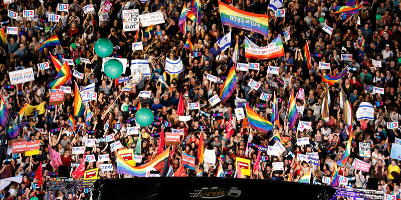 Participants attend a demonstration in Tel Aviv on July 22, 2018, to protest a new surrogacy law that does not include gay couples. - The demonstration comes after parliament, earlier in the week, approved surrogacy for single women or those unable to bear children -- without granting the same right to same-sex couples or single men. (Photo by JACK GUEZ / AFP) (Photo credit should read JACK GUEZ/AFP/Getty Images)