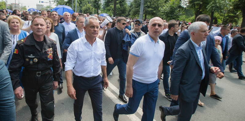 Vladimir Plahotniuc, secondo da sinistra, e l'ex primo ministro moldavo Pavel Filip, secondo da destra, alla guida di una manifestazione contro il nuovo governo. (AP Photo/Roveliu Buga)