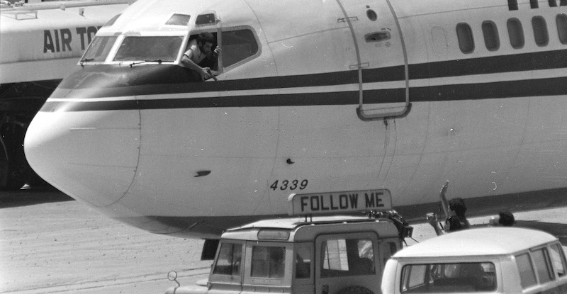 Un sequestratore parla con alcuni giornalisti di ABC all'aeroporto di Beirut il 19 giugno 1985 (AP Photo/Herve Merliac)