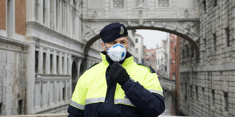 Un poliziotto con la mascherina a Venezia. (ANSA/ANDREA MEROLA)