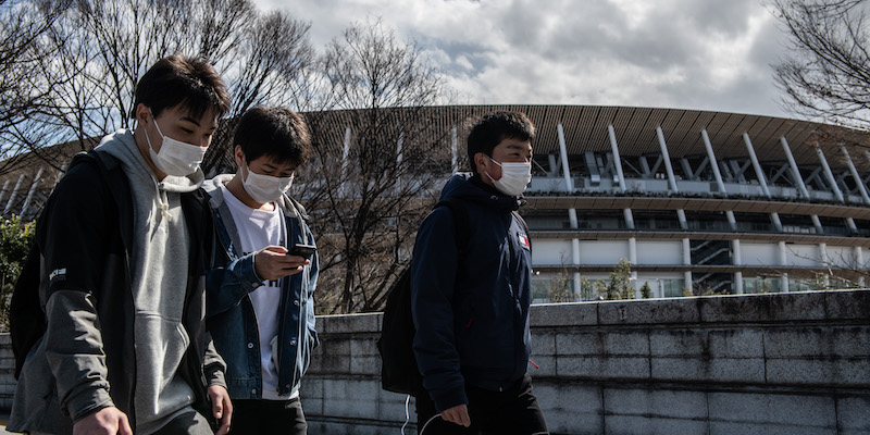 Passanti davanti al Nuovo Stadio Nazionale di Tokyo (Carl Court/Getty Images)