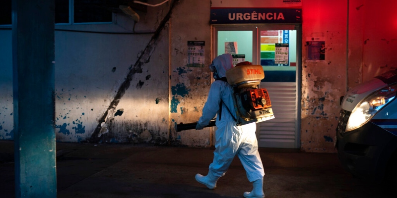 Un operatore spruzza disinfettante all'esterno di un ospedale a Manacapuru, nello stato di Amazonas, in Brasile, martedì 2 giugno 2020. (AP Photo/ Felipe Dana)