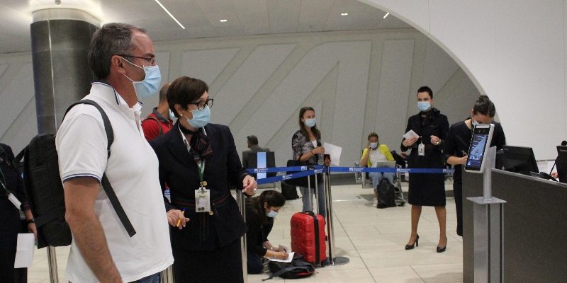 Passeggeri con mascherine protettive a un gate di imbarco all'aeroporto "Leonardo da Vinci" di Roma, il 1° luglio del 2020 (ANSA/Telenews