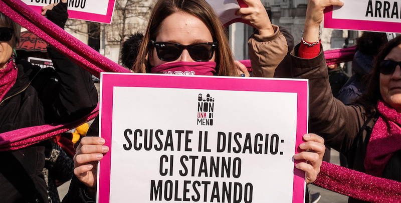 Un momento del flashmob di denuncia sulla violenza contro le donne di 'Non una di meno' con le partecipanti che tenevano in mano cartelli con le scritte 'Scusate il disagio: ci stanno molestando' o 'Scusate il disagio: ci stanno licenziando' e ancora 'Scusate il disagio: ci stanno stuprando', Milano, 8 febbraio 2020. Ansa/Matteo Corner