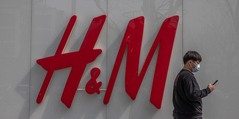 Un uomo cammina di fianco a un negozio di H&M a Pechino, in Cina, il 25 marzo 2021 (EPA/ROMAN PILIPEY/ANSA)