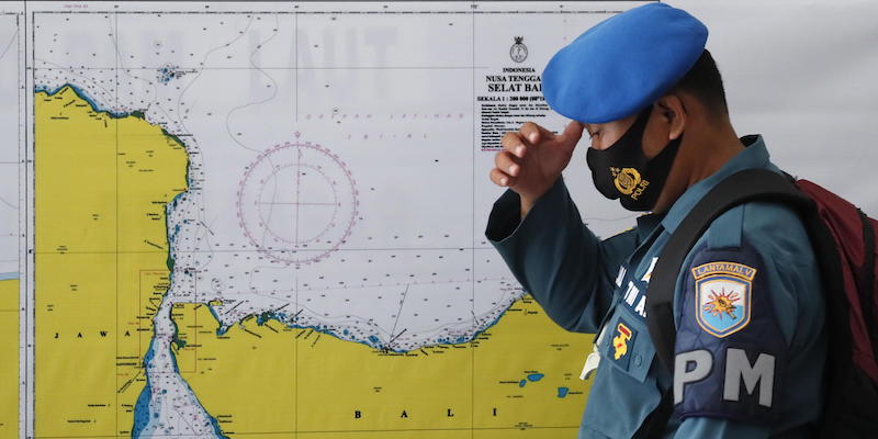 Un ufficiale militare davanti a una mappa in cui si vede il mare a nord dell'isola di Bali, dove è scomparso il sottomarino indonesiano (EPA/MADE NAGI/ANSA)