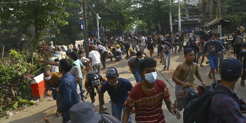 I manifestanti vengono dispersi dopo essersi scontrati con la polizia a Yangon, in Myanmar (AP Photo/File)