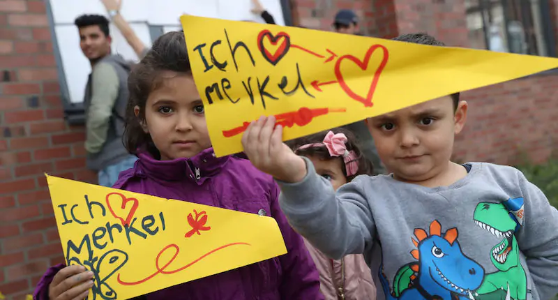 Una bambina e un bambino con cartelli che dicono in tedesco "Mi piace Merkel". Wismar, Germania, 19 settembre 2017 (Sean Gallup/ Getty Images)
