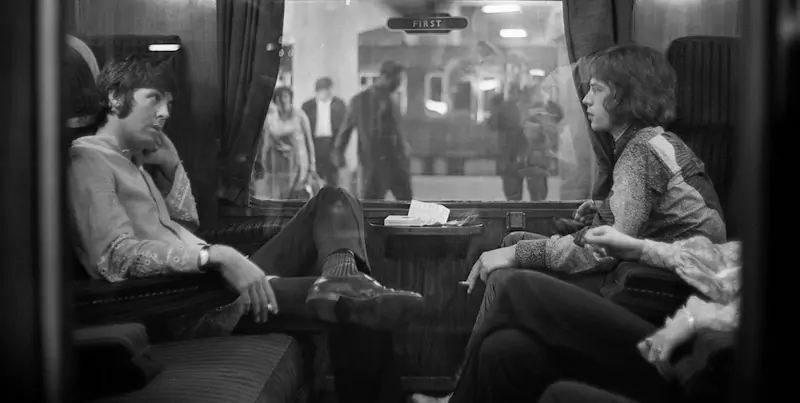 Paul McCartney e Mick Jagger su un treno alla Euston Station di Londra, nel 1969. (Victor Blackman/Express/Getty Images)