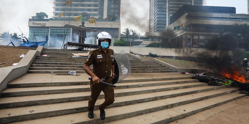 Un agente di polizia davanti alla residenza ufficiale del primo ministro a Colombo, Sri Lanka, 9 maggio (EPA/ Chamila Karunarathne via ANSA)