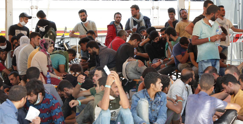 Migranti al loro arrivo sul molo Norimberga di Messina dopo essere stati soccorsi dalla Capitaneria di Porto mentre erano a bordo di un peschereccio al largo della Libia, 24 luglio 2022 (ANSA/CARMELO IMBESI)