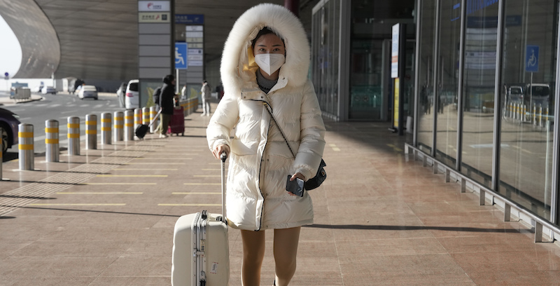 Una donna all'aeroporto di Pechino (AP Photo/Ng Han Guan)