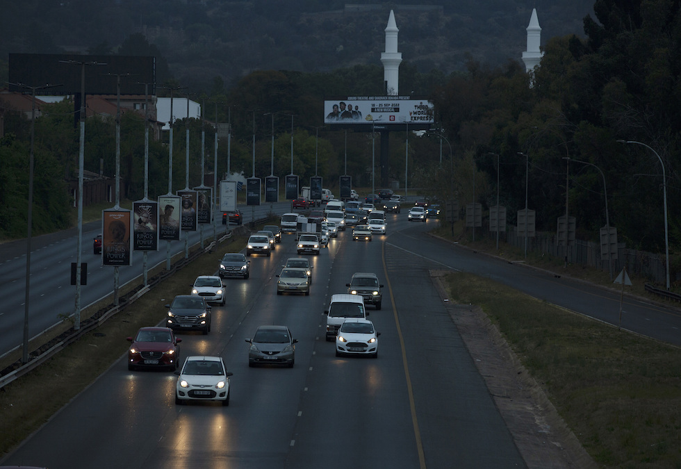 Automobili viaggiano su una strada senza illuminazione a causa dei blackout a Johannesburg, nel settembre del 2022