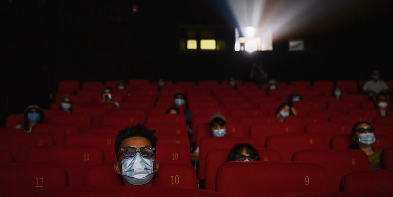 People wear protective masks as they watch a movie in 3D at a theatre in Beijing, Chinaon on 24 July. Photo: Kevin Frayer/Getty Images