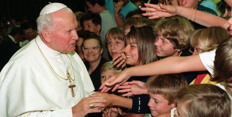 Giovanni Paolo II con dei bambini durante un'udienza in Vaticano, 28 agosto 1996 (AP Photo/Massimo Sambucetti)