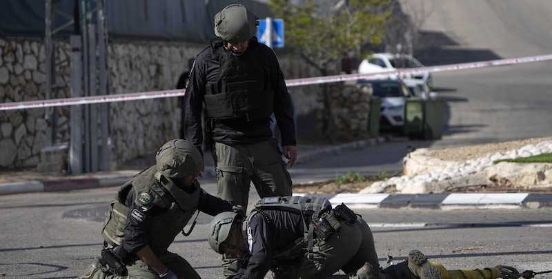 La polizia israeliana rimuove i detriti di un razzo caduto a Shlomi, nel nord del paese (AP Photo/Ariel Schalit)