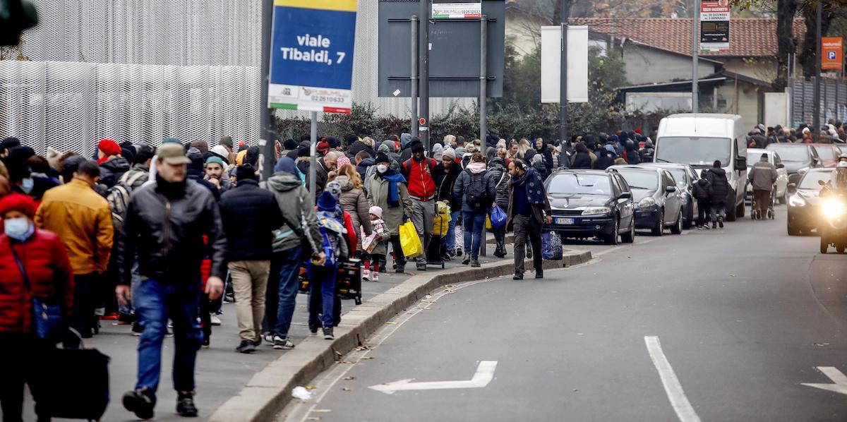 Persone in fila per la distribuzione degli alimenti al Pane Quotidiano, a Milano (ANSA/MOURAD BALTI TOUATI)