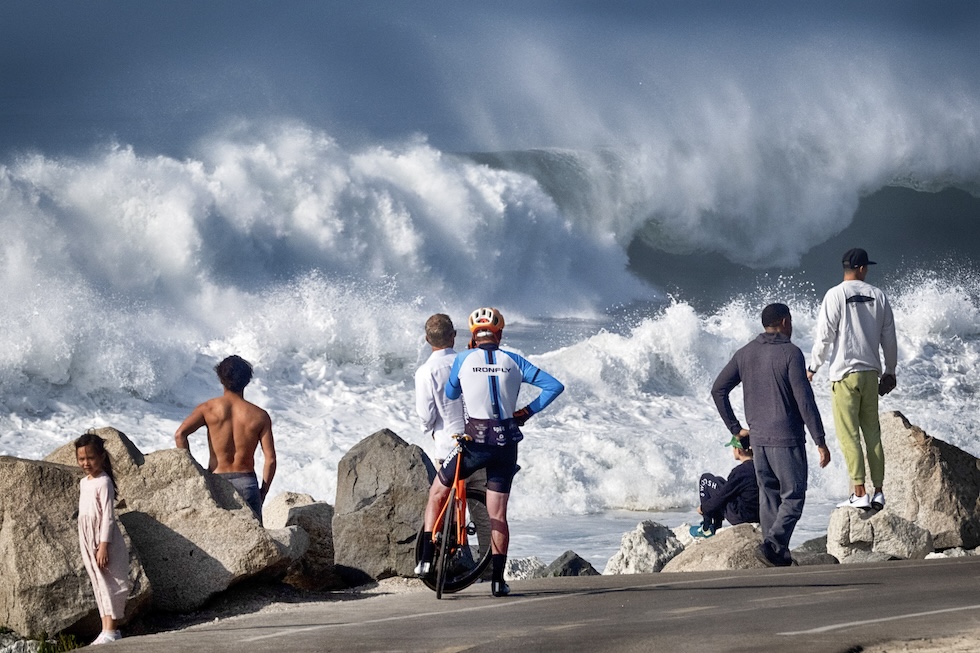 Persone osservano le onde a Manhattan Beach, Los Angeles, giovedì 28 dicembre