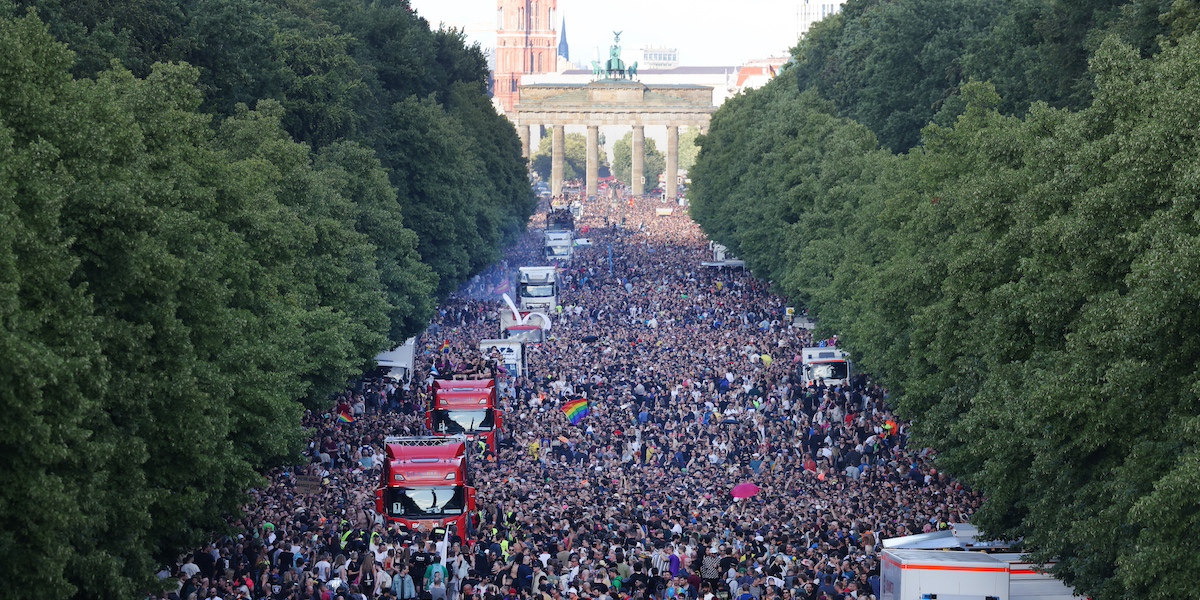 Una folla di persone in lungo viale durante il festival di musica dance “Rave the Planet”, nel Tiergarten a Berlino, il 9 luglio 2022