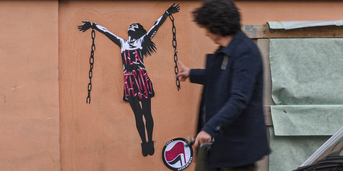un murale che rappresenta una donna con le mani alzate che spezza le catene che ha ai polsi