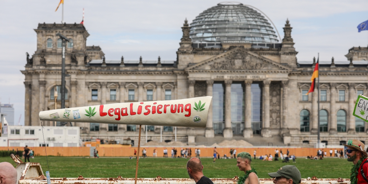 un cartellone a forma di canna che dice "legalizzatela" in tedesco
