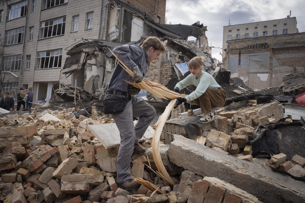 Studenti e volontari tra i detriti dell'accademia d'arte statale di Kiev, parzialmente danneggiata da un bombardamento russo di alcuni giorni fa