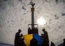 Alcuni soldati posano una bandiera ucraina sopra la bara di un commilitone morto, durante il suo funerale