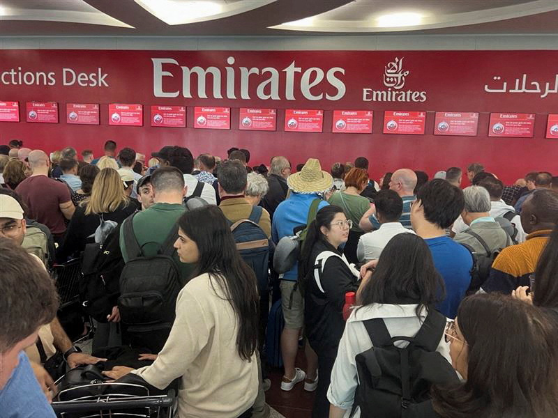 Passeggeri in coda davanti al desk di Emirates all'aeroporto di Dubai, 17 aprile 2024 