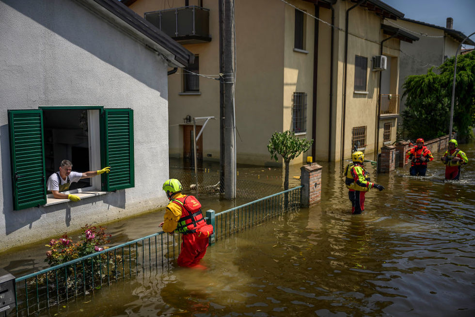 Vigili del fuoco assistono un alluvionato a Conselice, in Romagna (Antonio Masiello/Getty Images)