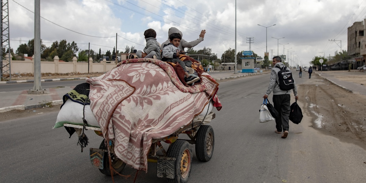 Alcune persone, tra cui due bambini, su un carro per andare via da Rafah (EPA/ HAITHAM IMAD via ANSA)