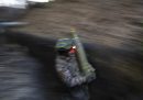 Un soldato ucraino trasporta un proiettile d'artiglieria durante i combattimenti nel nord-est dell'Ucraina