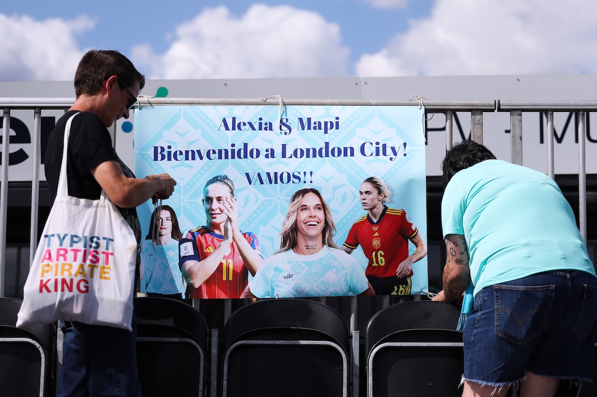 Tifosi delle London City Lionesses appendono un cartello per le calciatrici Alexia Putellas e Mapi Léon durante l'amichevole contro l'Atletico Madrid (Catherine Ivill - AMA/Getty Images)